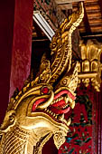 Wat Xieng Thong temple in Luang Prabang, Laos. Detail of flame-like gilded lacquered carvings of sacred serpents or nagas on the Royal Funerary Chariot. 
